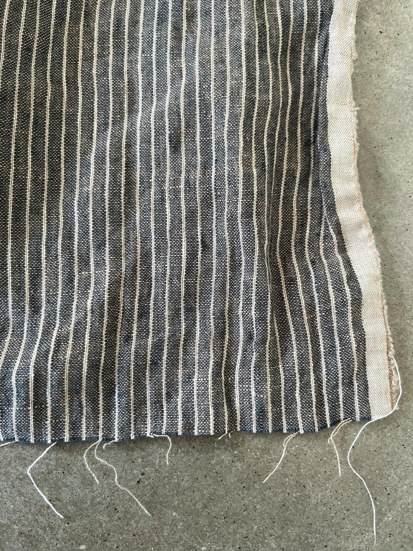 Striped fabric on a concrete surface