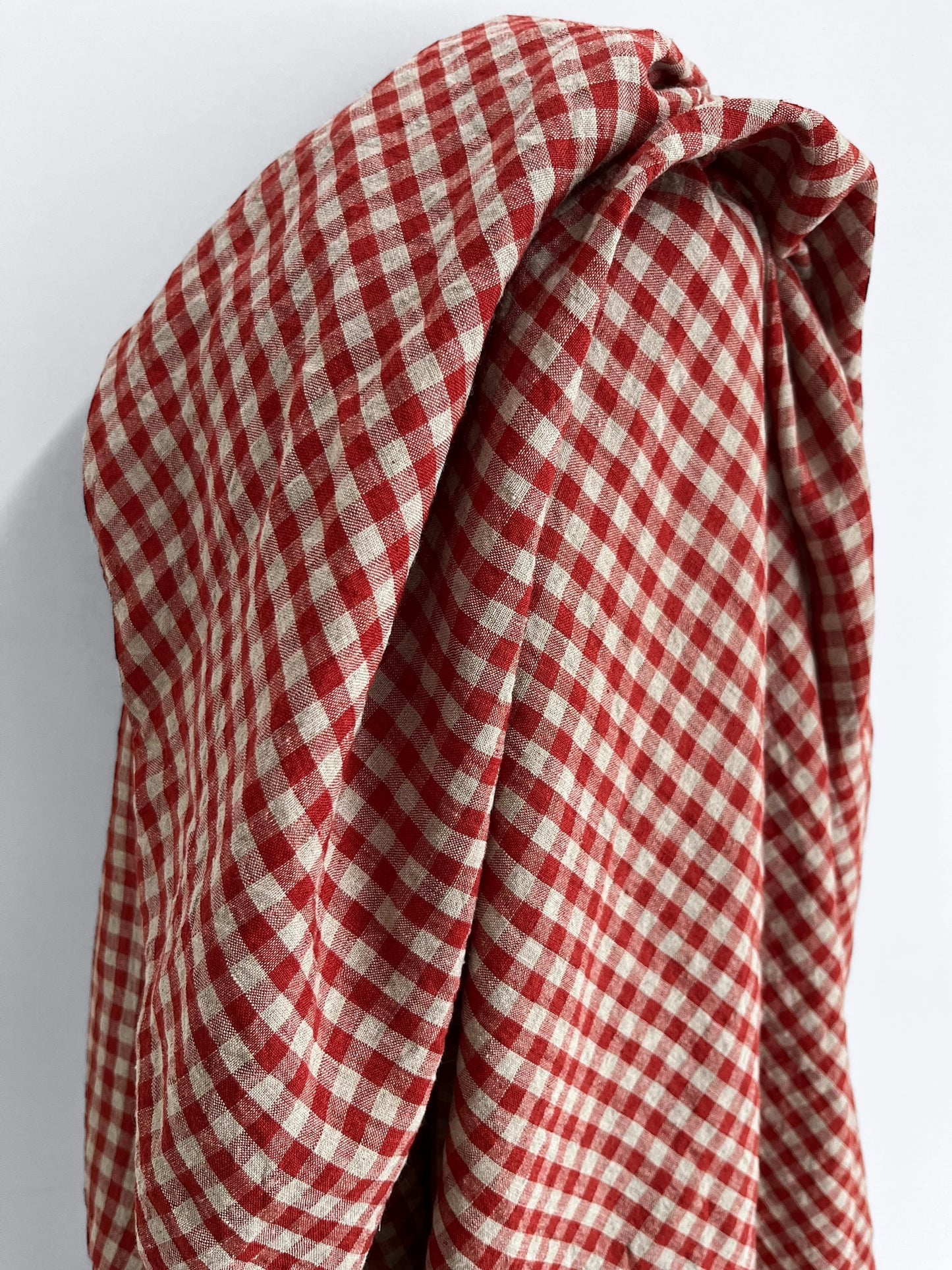 Red and white checkered fabric on a light gray background