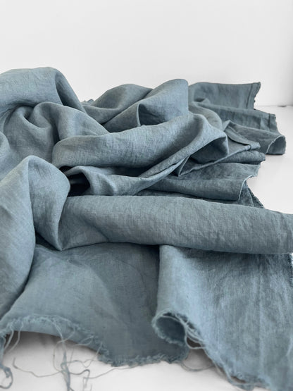 dusty blue linen fabric on a white surface