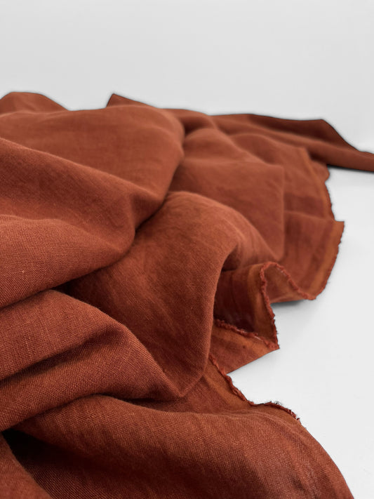 Rusty brown linen fabric on a white background
