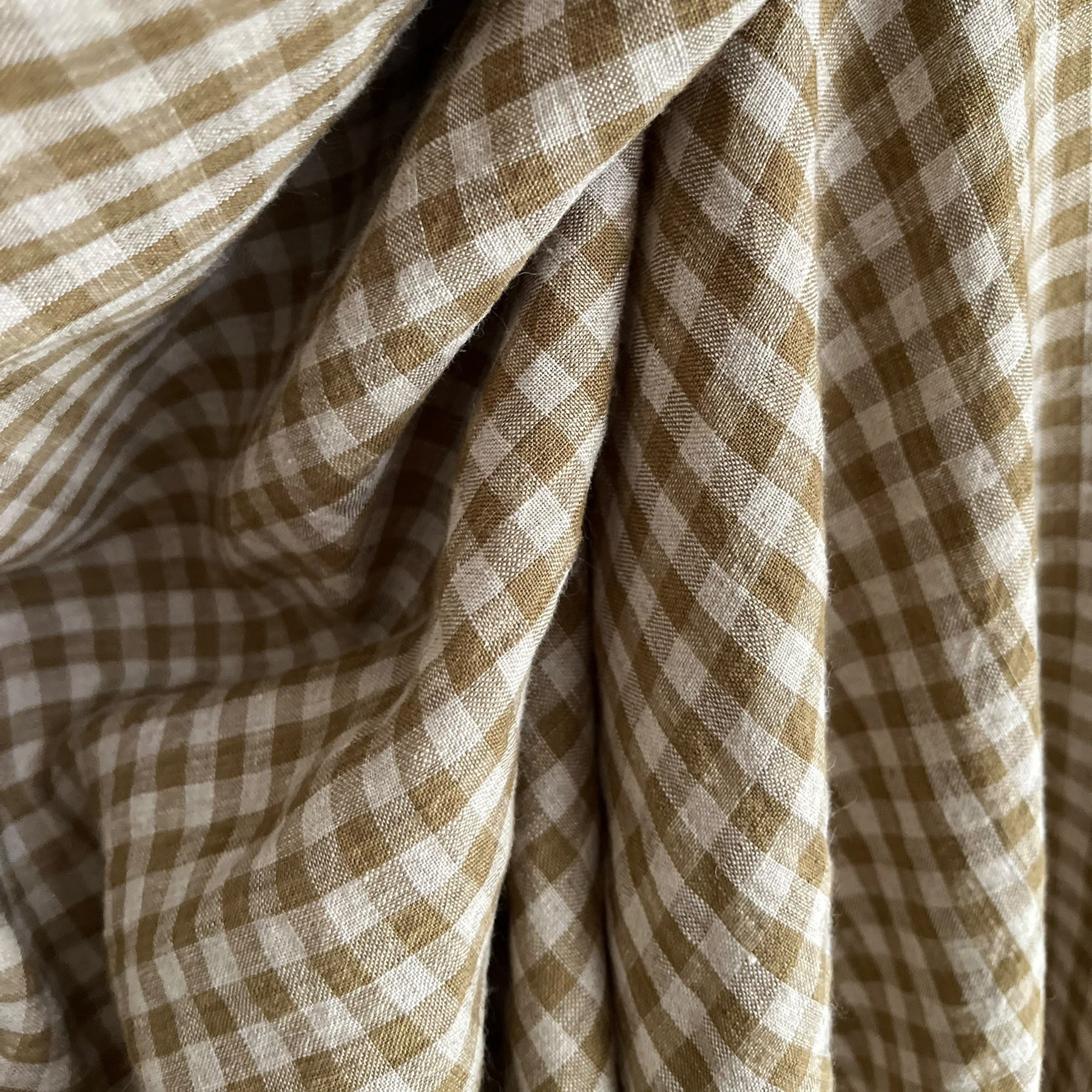 Close-up of olive green and natural flax checkered fabric